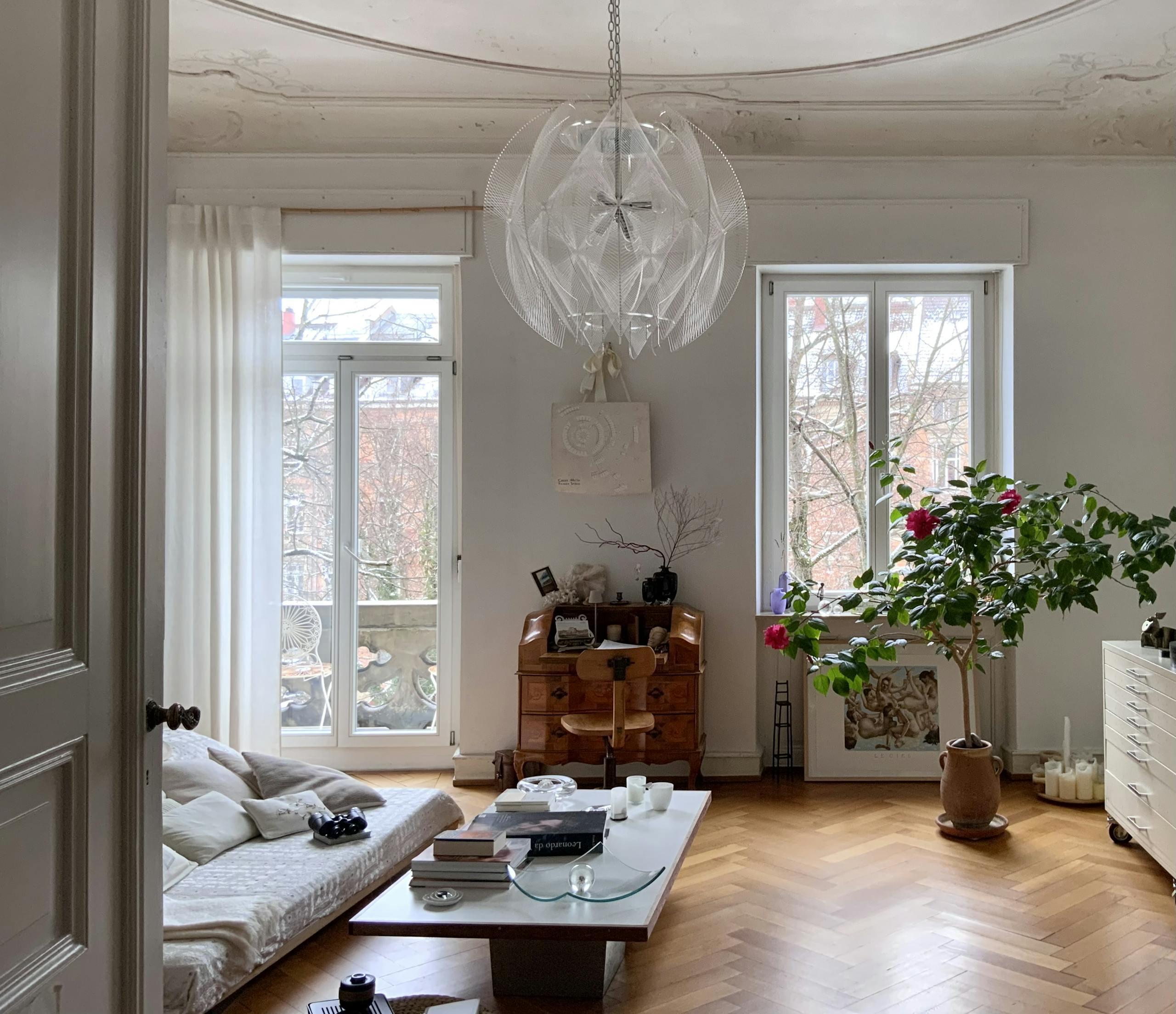 Bright modern living room interior with minimalist furniture, natural light, and neutral color palette
