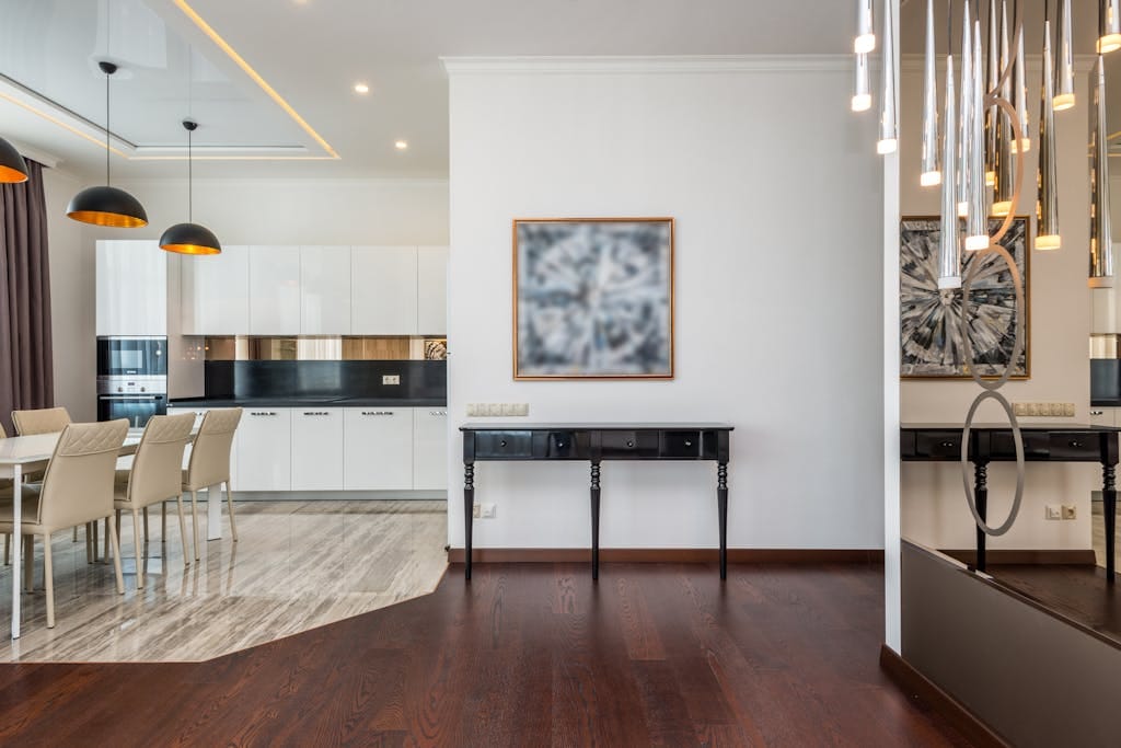 Sleek modern kitchen and living area with high-end furnishings and stylish lighting.